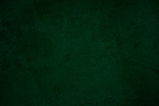 Green chalkboard texture for school display backdrop. chalk traces erased with copy space for add text or graphic design grunge background. Green board. Dark green wall backdrop. Education concepts.