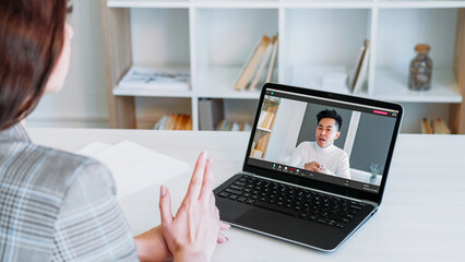Fototapeta na wymiar Video call. Web communication. Digital conference. Confident CEO business man speaking on laptop screen to employee woman at virtual office workplace.