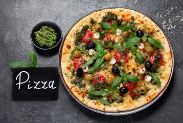 Delicious pizza with cherry tomatoes and fresh basil.