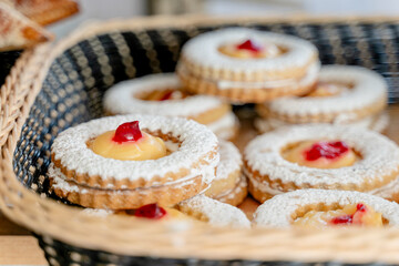 jam-filled cookies with cherry on top in a basket - Mexican bread