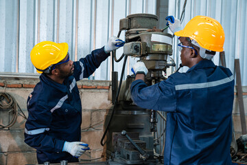 Team of technician worker checking and repair pressing metal machine at factory, Machine maintenance technician operation concept.