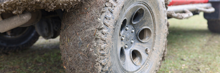 Closeup of dirty wheel of off road vehicle.