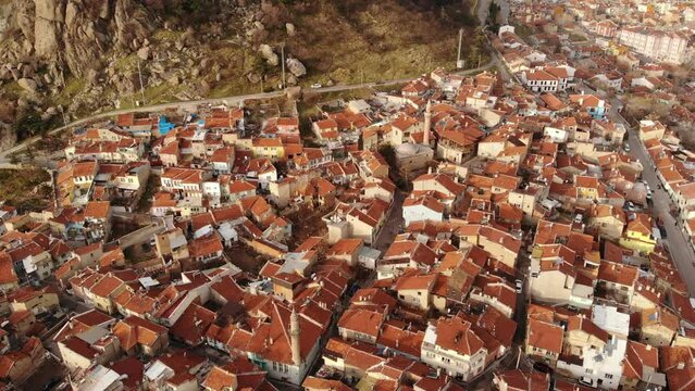 Aerial view of Afyonkarahisar cityscape with similar brownish tiled roofs on residential buildings on sunny winter day, Turkey. High quality 4k footage