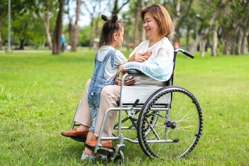 Portrait of happy love asian grandmother and asian little cute girl play and enjoy relax on bed at home.senior, insurance, care.Young girl with their laughing grandparents smiling together.Family