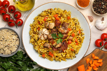 Delicious pilaf and products on table, flat lay