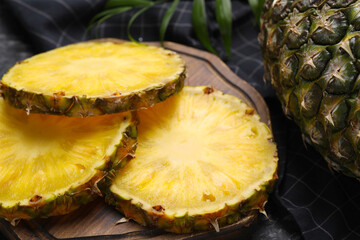Slices of tasty ripe pineapple on table, closeup
