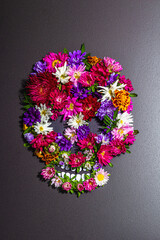 Paper human skull for Mexico's Day of the Dead (El Dia de Muertos) with traditional flowers