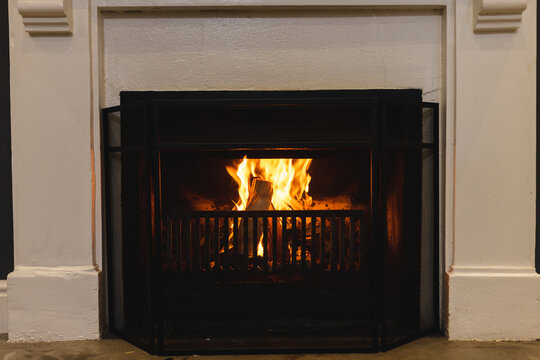 Close up of open fire in fireplace in living room