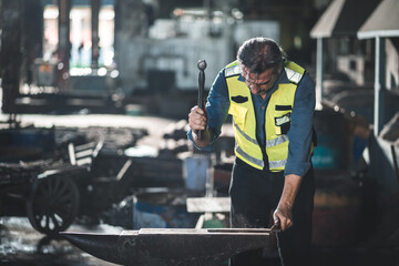 Fototapeta premium foreman with hard hat working vest on a construction site, middle aged or older technician engineer man in industrial factory, Professional heavy industry worker wearing uniform, men at work concept