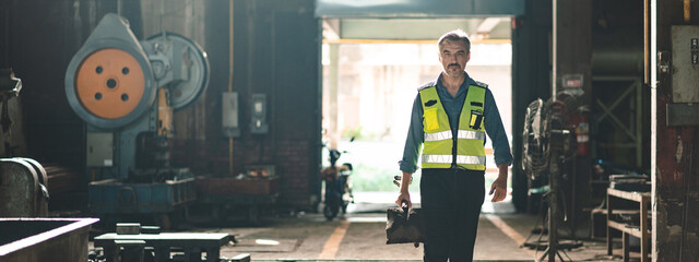 foreman with hard hat working vest on a construction site, middle aged or older technician engineer man in industrial factory, Professional heavy industry worker wearing uniform, men at work concept