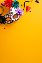 Lively Day of the Dead festivity concept. A top-down vertical photo of a decorated skull mask set...