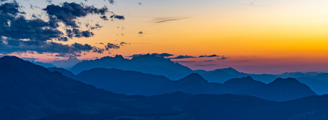 Mountain silhouettes in the panorama of the Bregenzerwald, with Säntis in the background. Sunset...