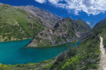 Fototapeta na wymiar Panorama landscape with a blue lake in the mountains in summer. Koksai Ainakol Lake in Tien Shan Mountains in Asia in Kazakhstan