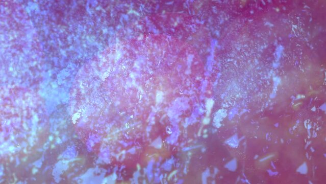 Blue nebula made up of small particles moves slowly against a purple background.