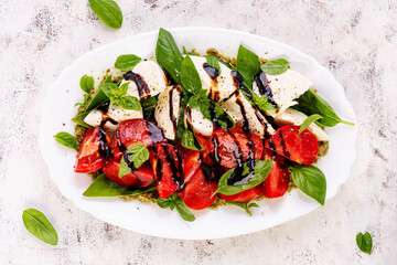 Caprese salad tomato for concept design. White background, close up. Food concept.  Top view