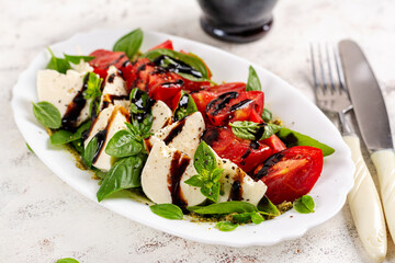 Caprese salad tomato for concept design. White background, close up. Food concept.