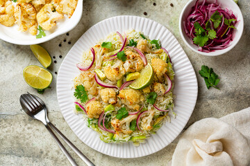 Roasted cauliflower salad with rice, avocado, cellery, marinated red onions, coriander leaf, olive...