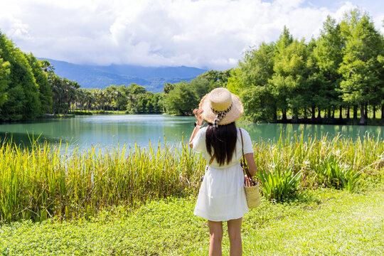 Tourist woman look at the water pond