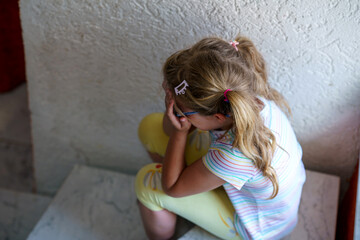 Lonely Upset Little Preschool Girl at Home. Sad Child Alone. Emotional Stress of Children, School, and Family Problems.