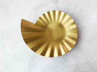 beautiful premium luxury branded metal plate design in shining gold color and ribbon on white marble table different angle top view photo shoot