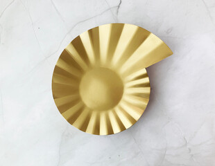 beautiful premium luxury branded metal plate design in shining gold color and ribbon on white marble table different angle top view photo shoot