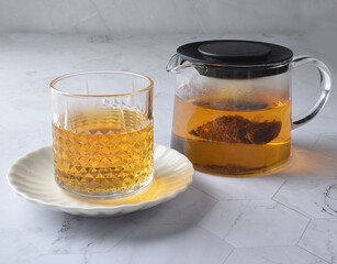 premium hot brew organic chinese green western black tea leaf bag hand pour in whisky glass pot and cup on luxury white marble table halal food beverage cafe drink menu design