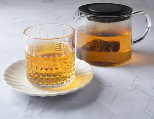 premium hot brew organic chinese green western black tea leaf bag hand pour in whisky glass pot and cup on luxury white marble table halal food beverage cafe drink menu design