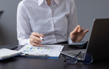 Fototapeta premium Financial Businesswomen analyze the graph of the company's performance to create profits and growth, Market research reports and income statistics, Financial and Accounting concept. 