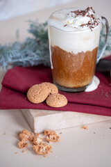 Still life with a cup of coffee latte, cookies and cade branch in Christmas mood. Small gold grater for chocolate. Copy Space