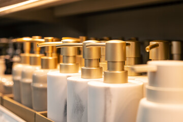 Containers for liquid soap or shampoo with a dispenser is sold in a supermarket.