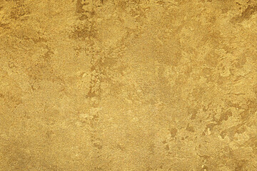 Texture of golden decorative plaster or concrete. Abstract gold grunge background.