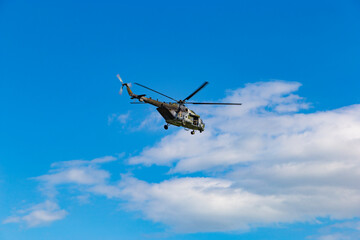 Military helicopter in the blue sky