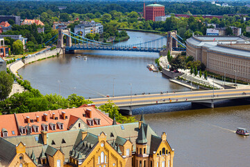 The Grunwald Bridge (Most Grunwaldzki) over Oder river in Wroclaw, Poland. View from the observation deck of the tower of Wroclaw cathedral (aka Katedra sw. Jana Chrzciciela) - obrazy, fototapety, plakaty