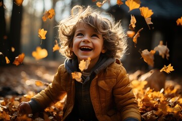 Little boy having fun during stroll in the forest at sunny autumn day. Child playing maple leaves. Baby tossing the leaves up. Active family time on nature. Hiking with little kids. Dry leaves rustle.
