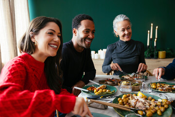 Smiling family having dinner together in dining room