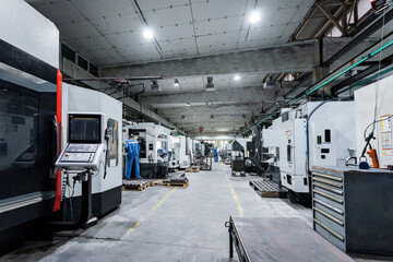 Technicians working and operating machinery in factory