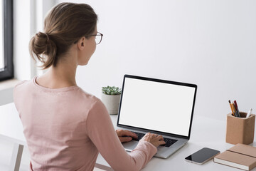Young woman working at home, Student girl using laptop computer with blank empty screen, online shopping, work or studying from home, freelance, online learning, distance education concept