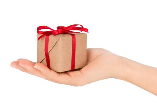 Christmas gift box in woman's hand isolated on transparent background. Gift box wrapped with craft paper and red ribbon