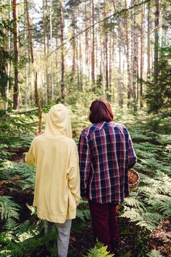 Boy with grandmother walking in forest
