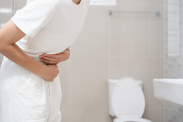 Constipation and diarrhea in bathroom. Hurt woman touch belly  stomach ache painful. colon...
