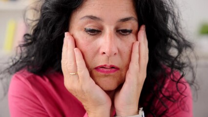 Closeup of sad middle aged woman thinking. Anxiety, depression, mourning and mental health concept