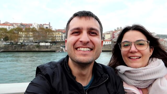 Smiling tourist couple on boat trip. Ravelo tour over Douro River in Porto