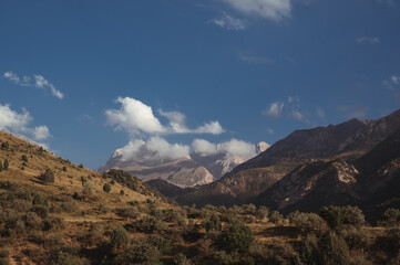 landscape with mountain peaks background the sky with clouds at sunset in a summer