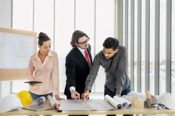 Engineer team meeting to inspect the construction blueprint drawings, work plan and distribute work before starting the building