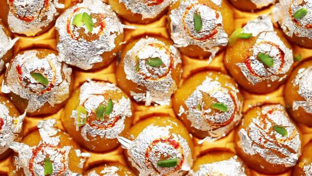 Close-up of an Indian Sweet "Motichoor Ladoo" also Called Boondi Ladoo garnished with silver leaf.