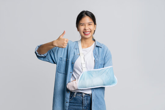 Asian female patient wearing plaster cast and arm support after injury from accident Life and accident insurance