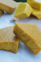 Little pieces of natural, pure organic yellow beeswax. Side view.