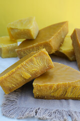 Pieces of organic beeswax. The use of beeswax in apitherapy. Production ingredient for medical and cosmetics. Side view.