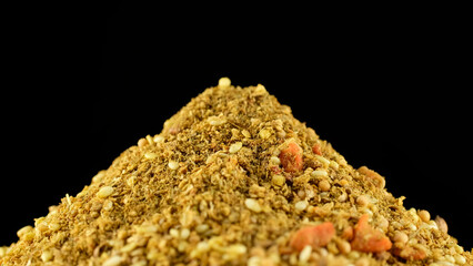 Heap of dry seasoning, black background. Natural seasoning for fish cooking