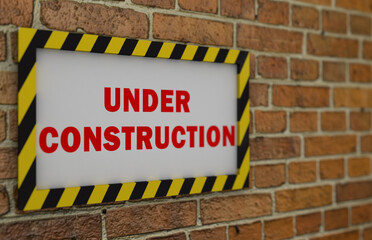 Naklejka premium Under construction sign on a brick wall.